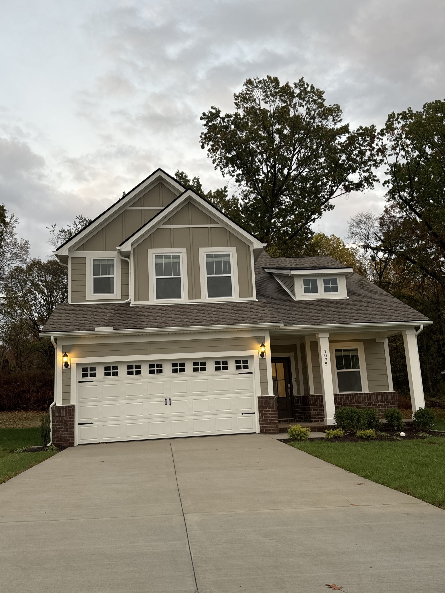 a front view of a house with a garden