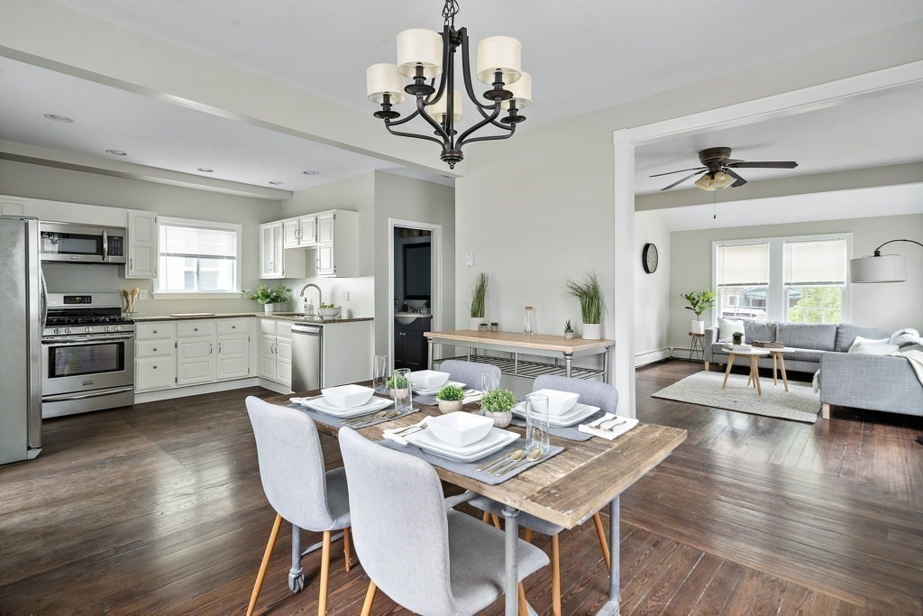 a view of a dining room with furniture wooden floor and chandelier