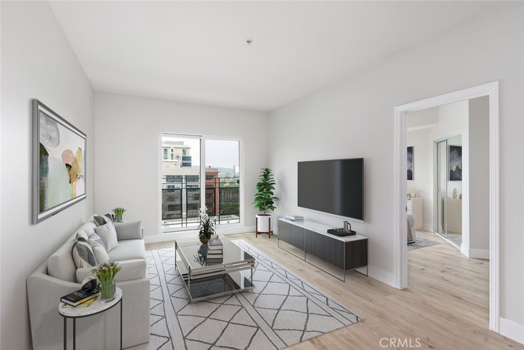 a living room with furniture a flat screen tv and large window