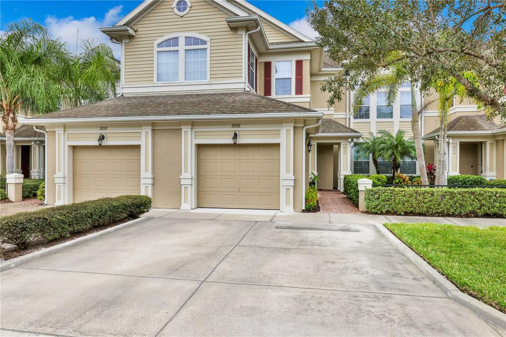 a front view of a house with a yard and garage