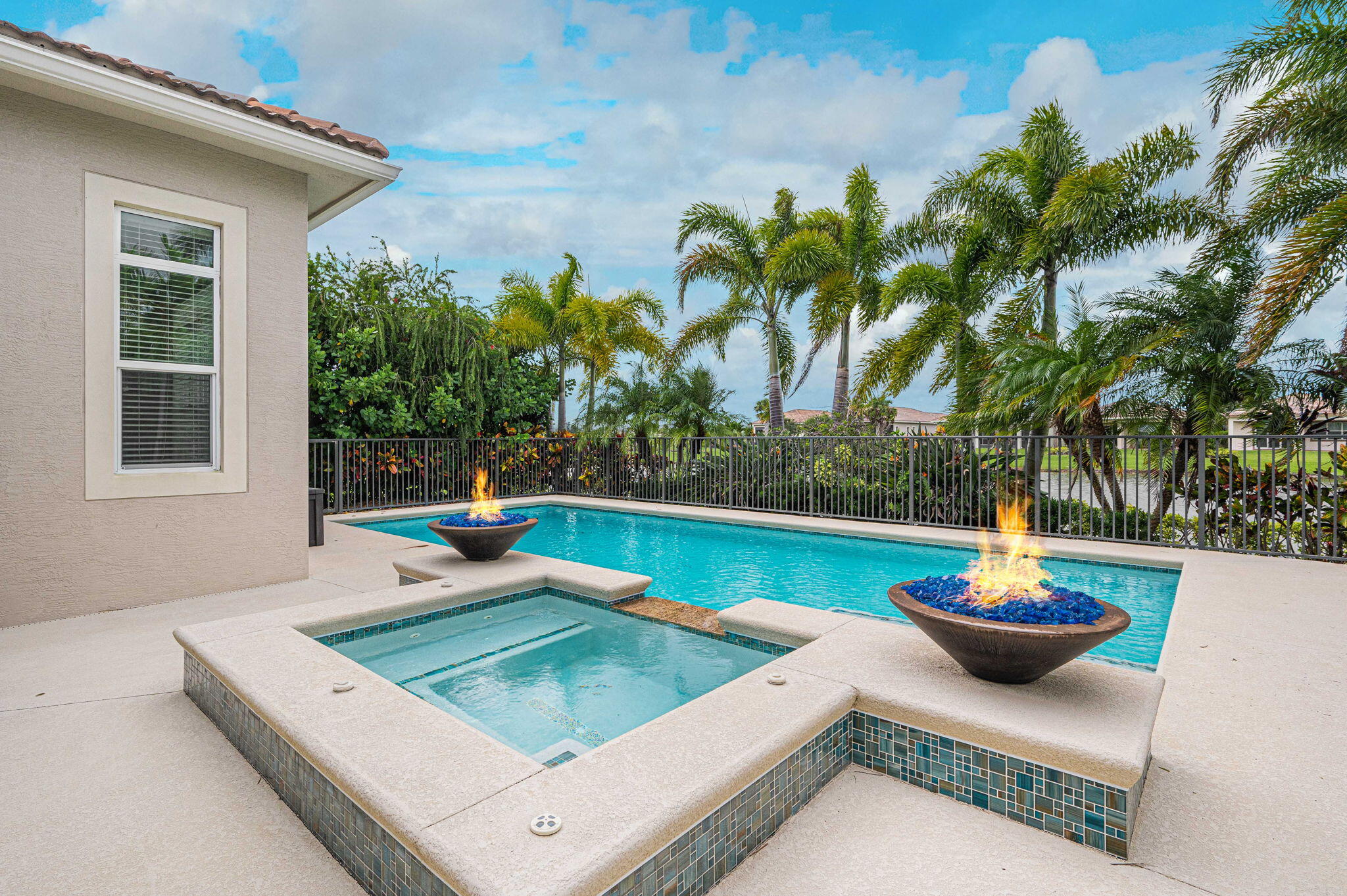 a view of a patio with swimming pool and furniture