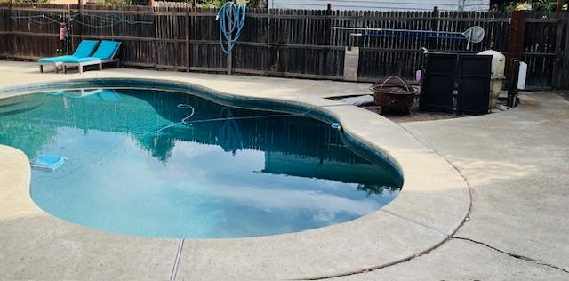 a view of a swimming pool with a outdoor seating