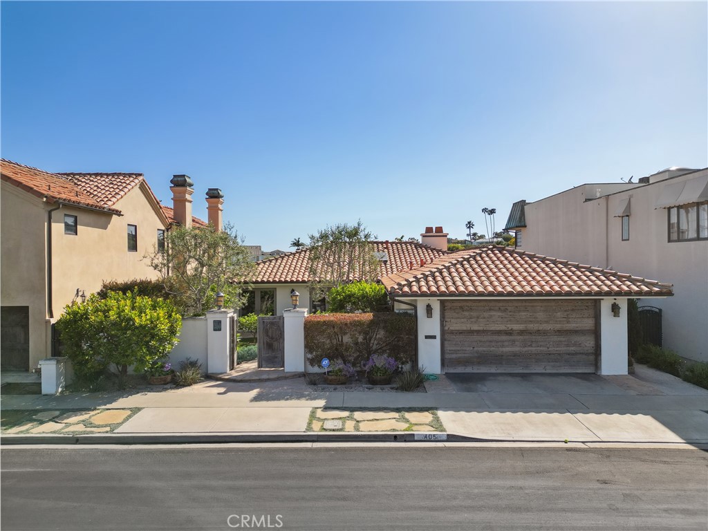 a front view of a house with a yard and a garage