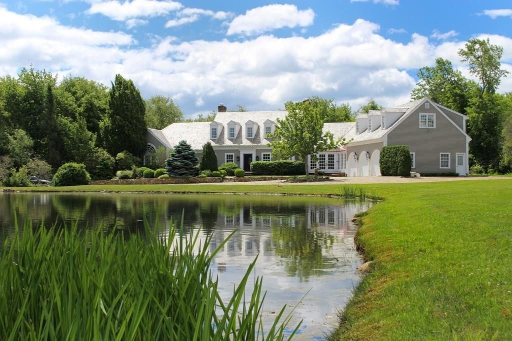 a view of a lake with a house in the background