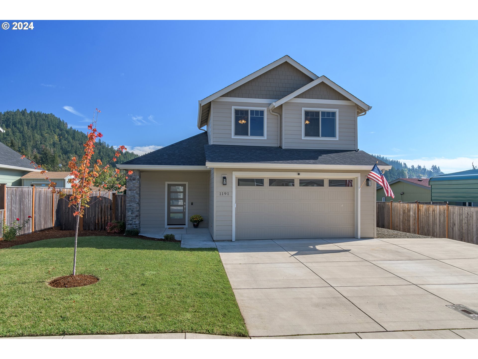 a front view of a house with a yard and garage