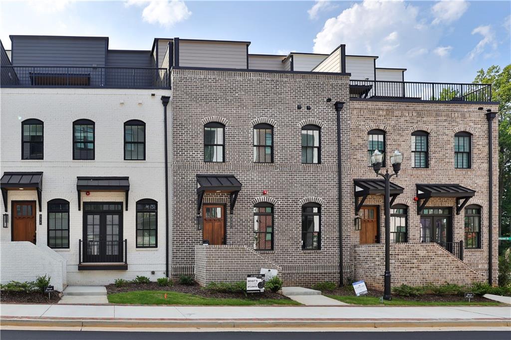 a front view of a building with a view of a yard