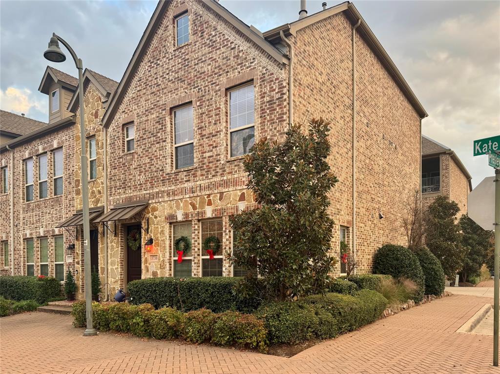 a view of a brick building next to a yard