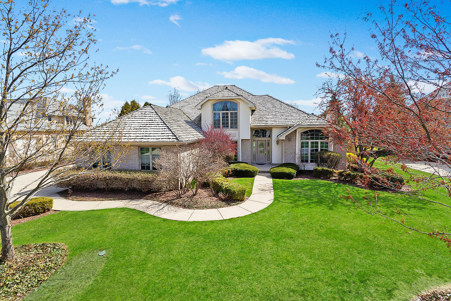 a front view of a house with a garden