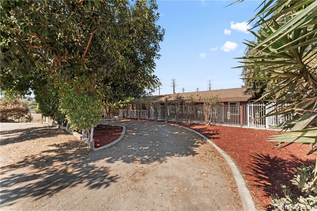 a view of a backyard with table and chairs and wooden fence