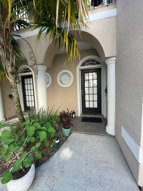 a view of a front door of the house and trees