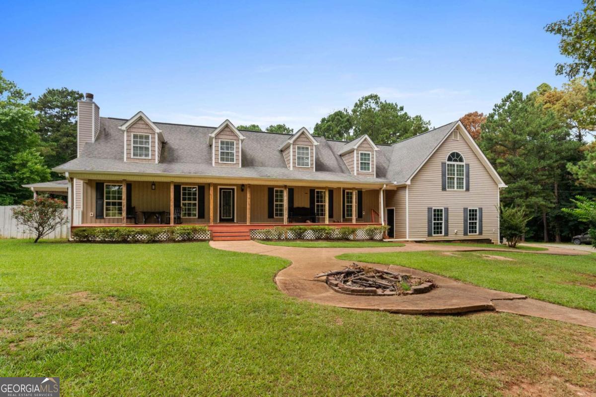 a front view of a house with a garden and porch