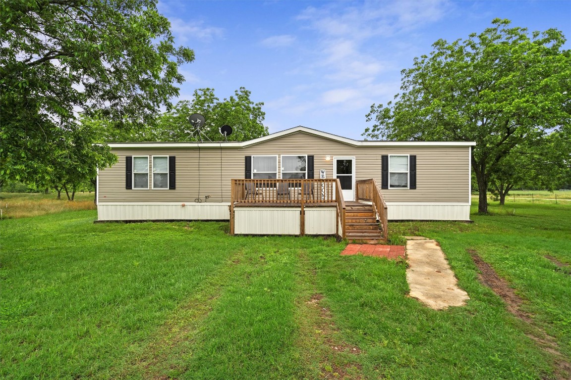 a view of a house with a yard and sitting area