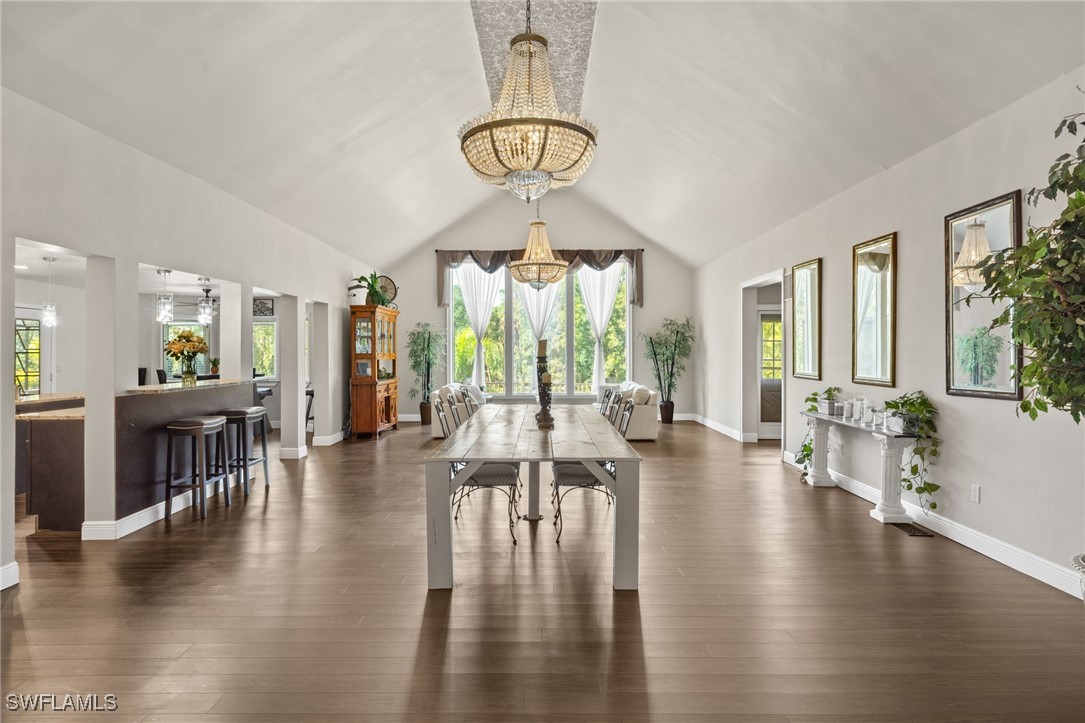 a view of a livingroom with furniture wooden floor and a floor to ceiling window