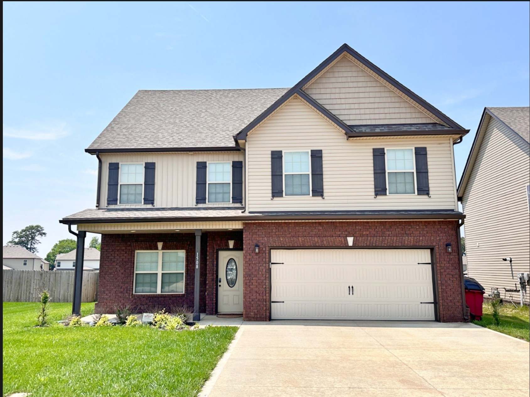 a view of a house with brick walls and a small yard