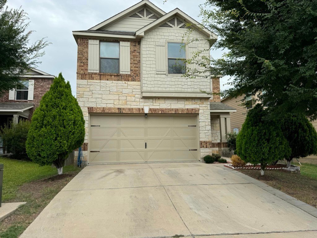 a view of a house with a yard and garage