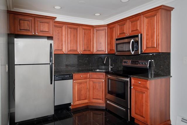 a kitchen with stainless steel appliances granite countertop a refrigerator stove top oven a sink and dishwasher