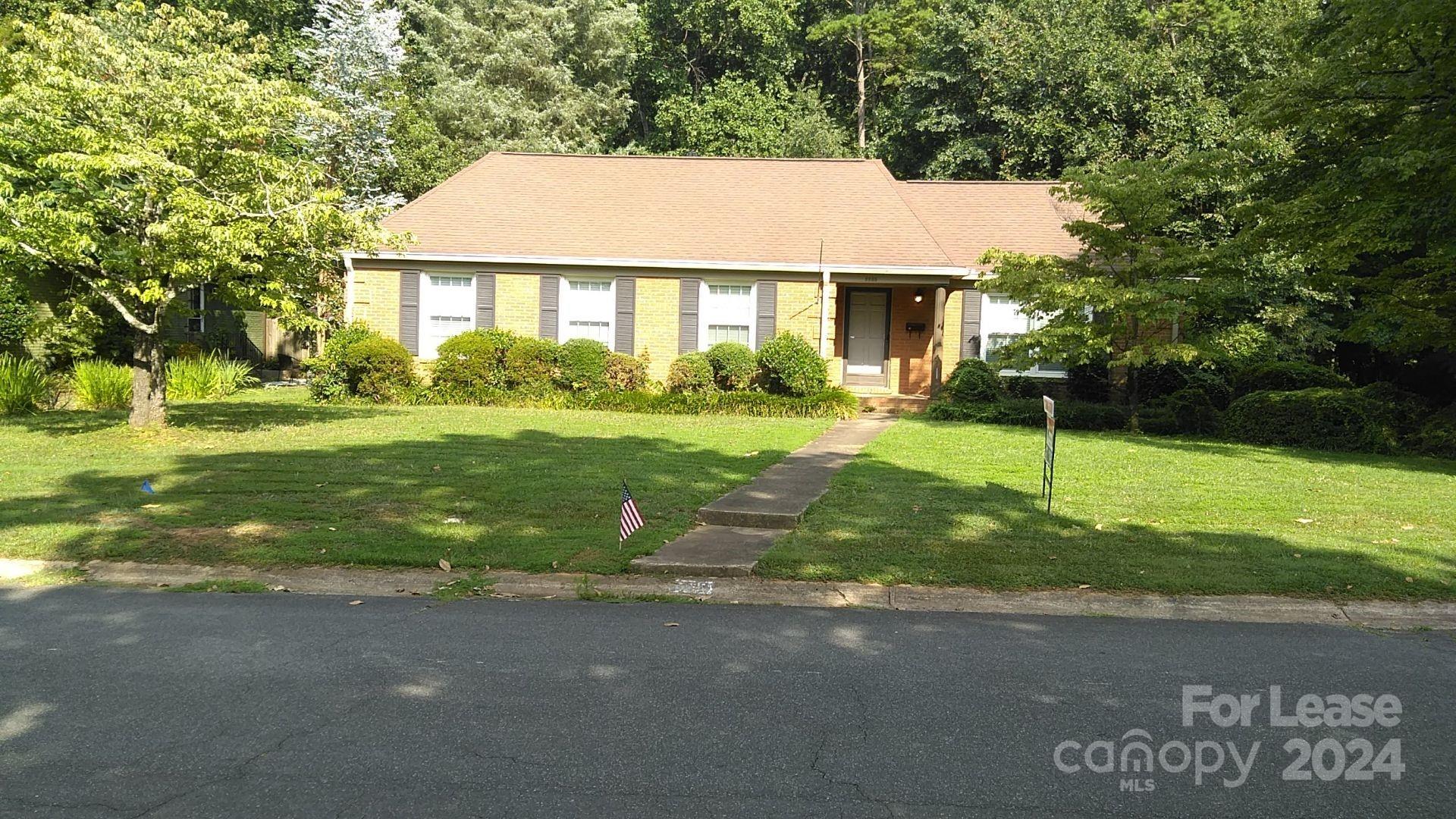 a view of a house with a yard and garage