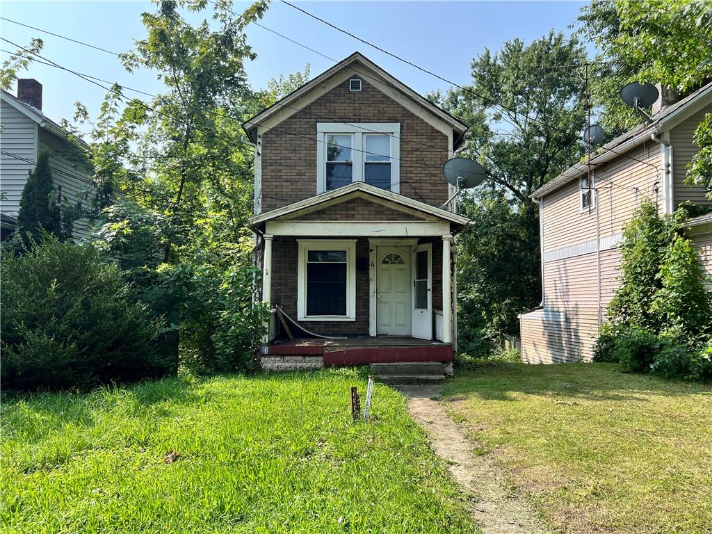 a front view of a house with garden