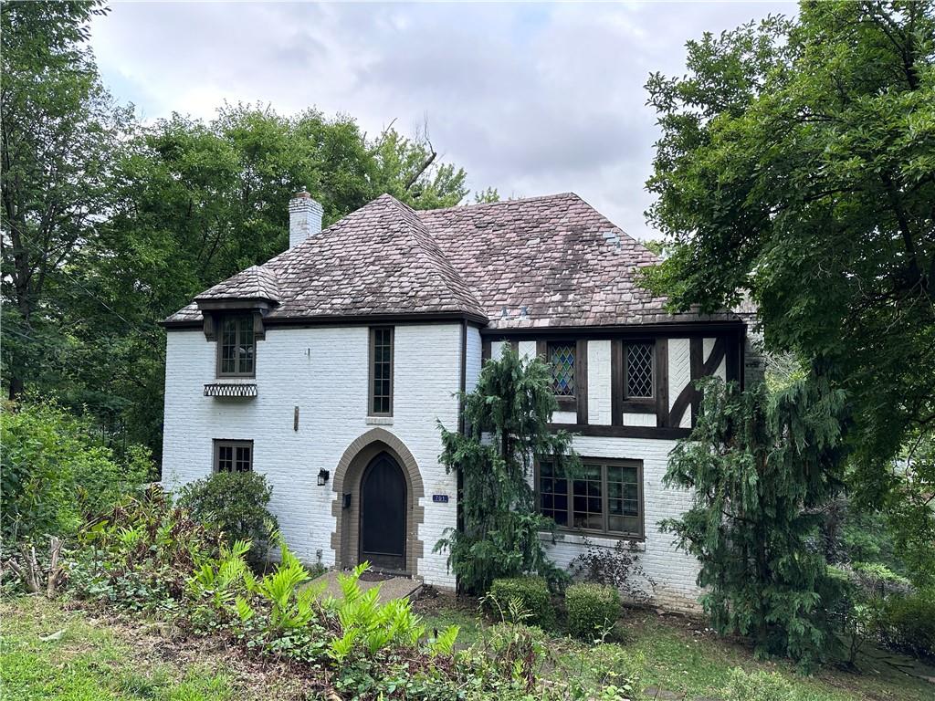 a front view of a house with a garden