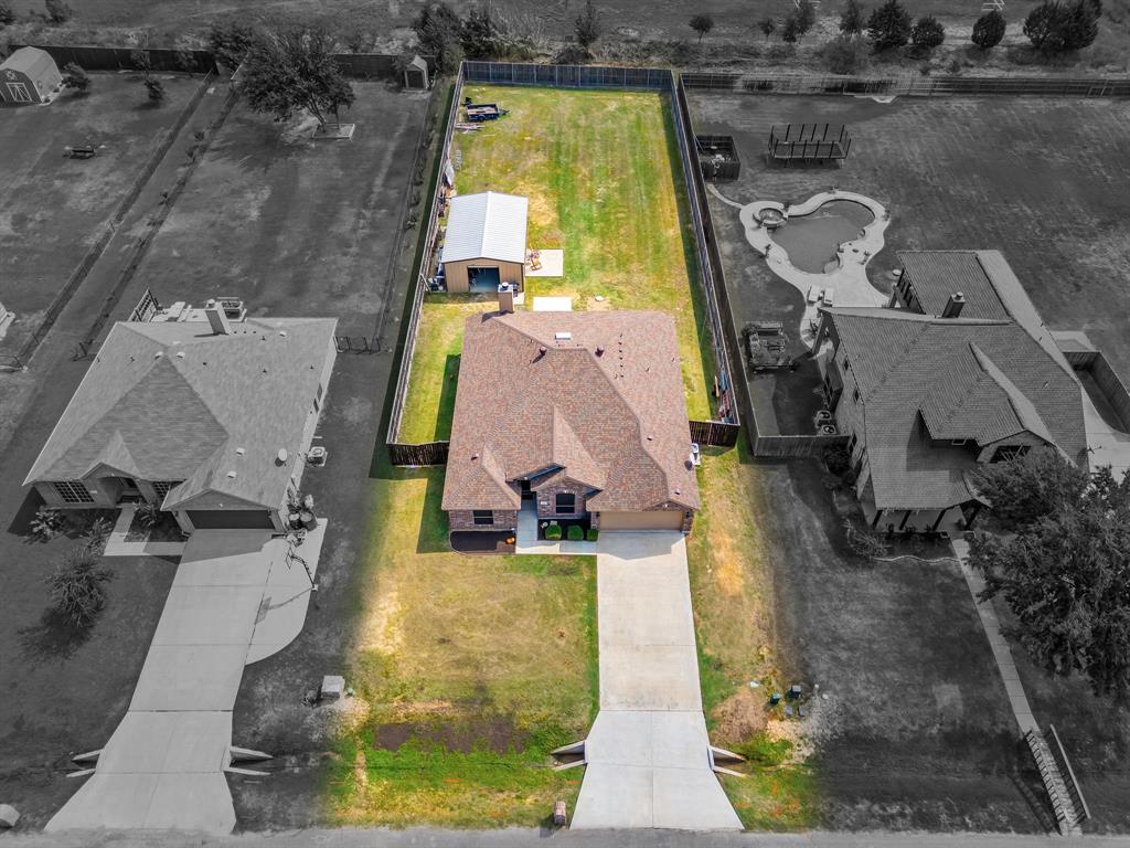 an aerial view of a house with a swimming pool