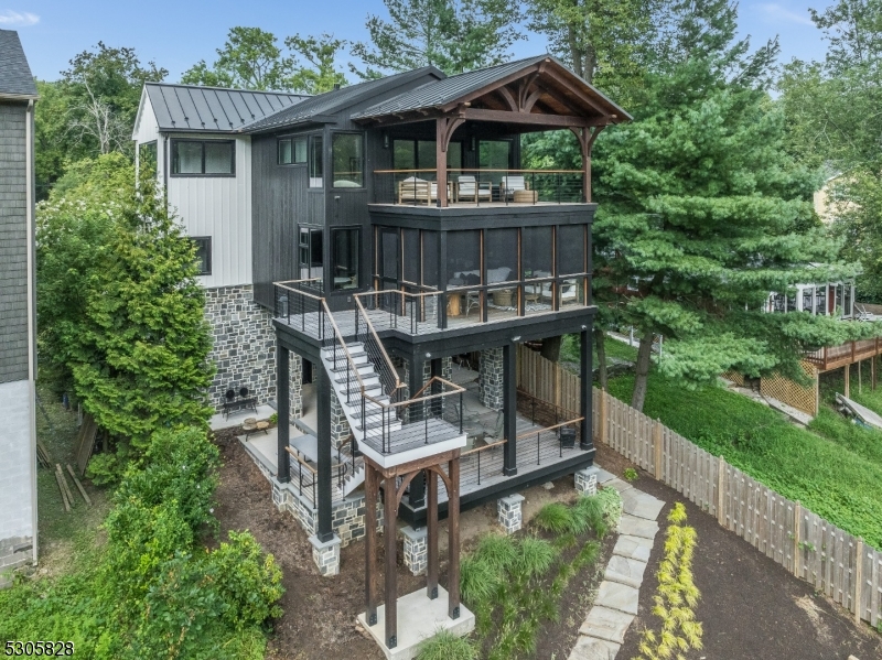 an aerial view of a house with yard porch and furniture