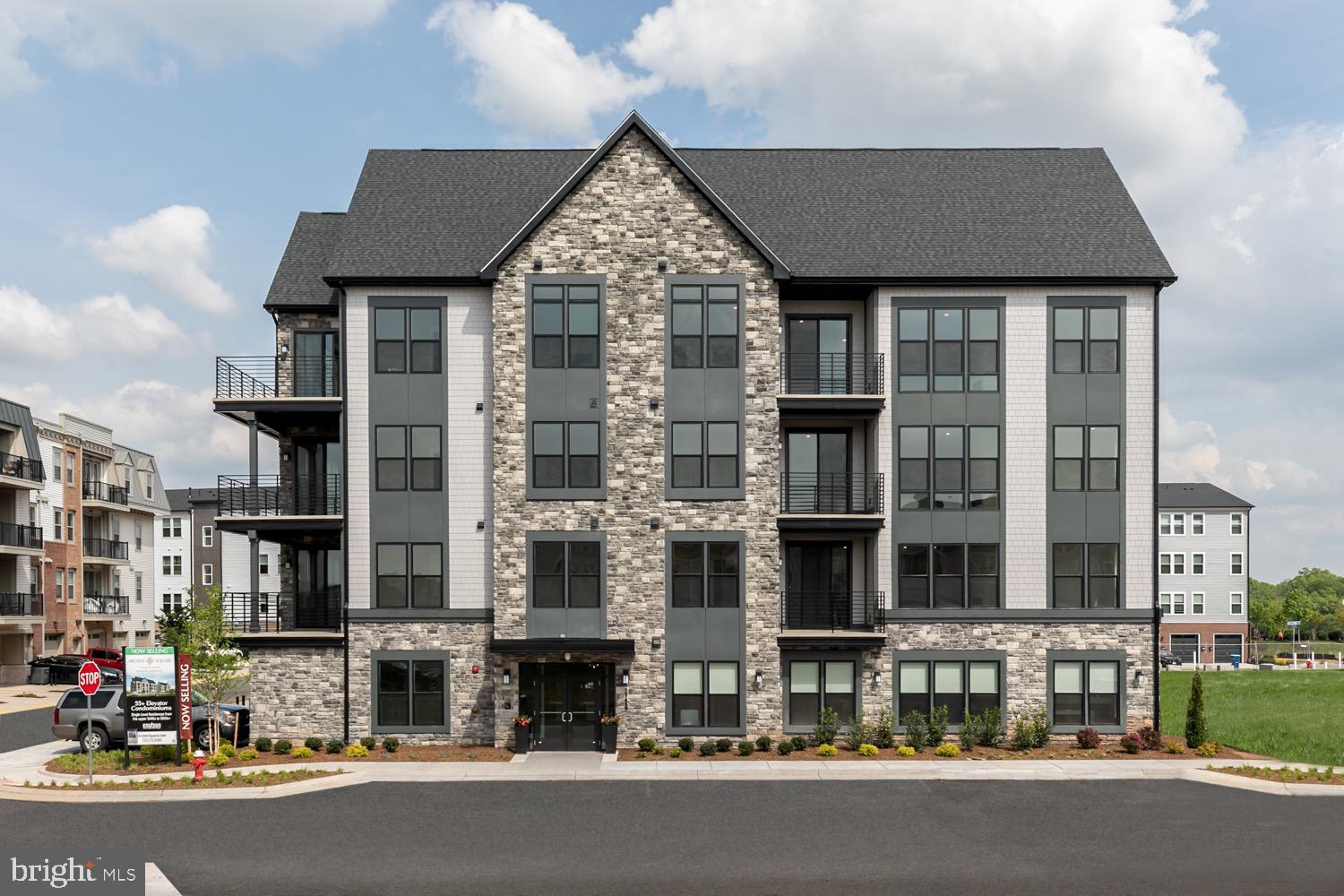 a front view of a residential apartment building with a yard