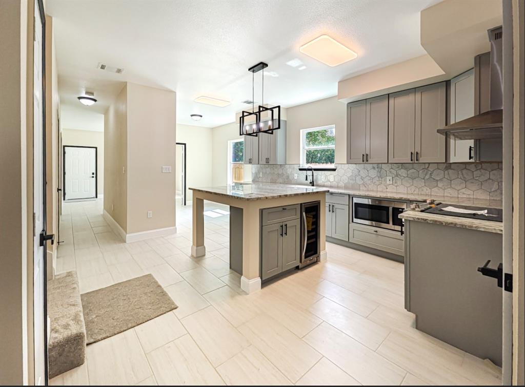 a kitchen with stainless steel appliances granite countertop a stove a sink dishwasher and a refrigerator