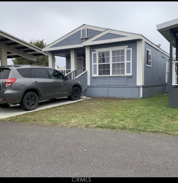 a front view of a house with a garden and parking space