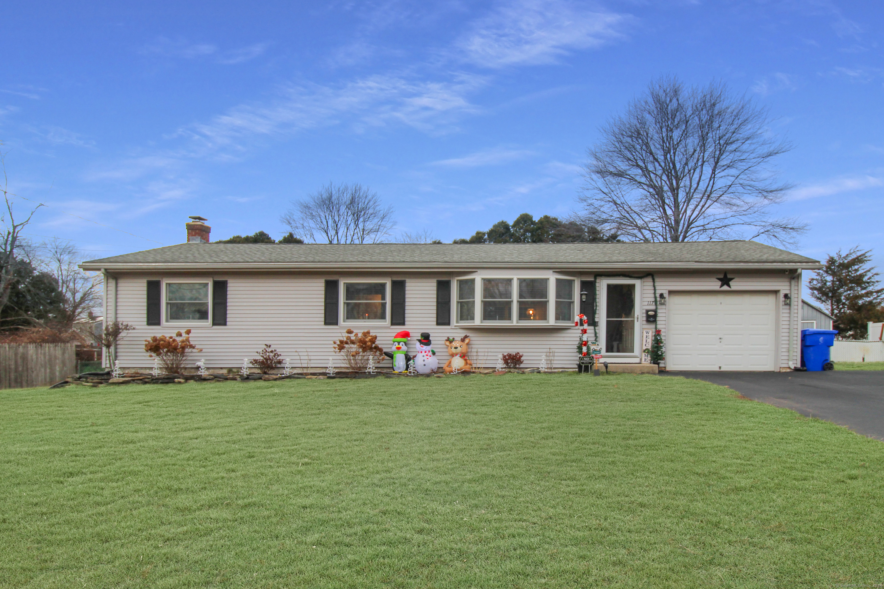 a front view of a house with a garden and yard