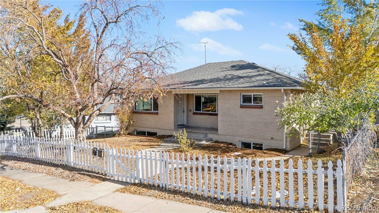 a view of a house with a wooden fence