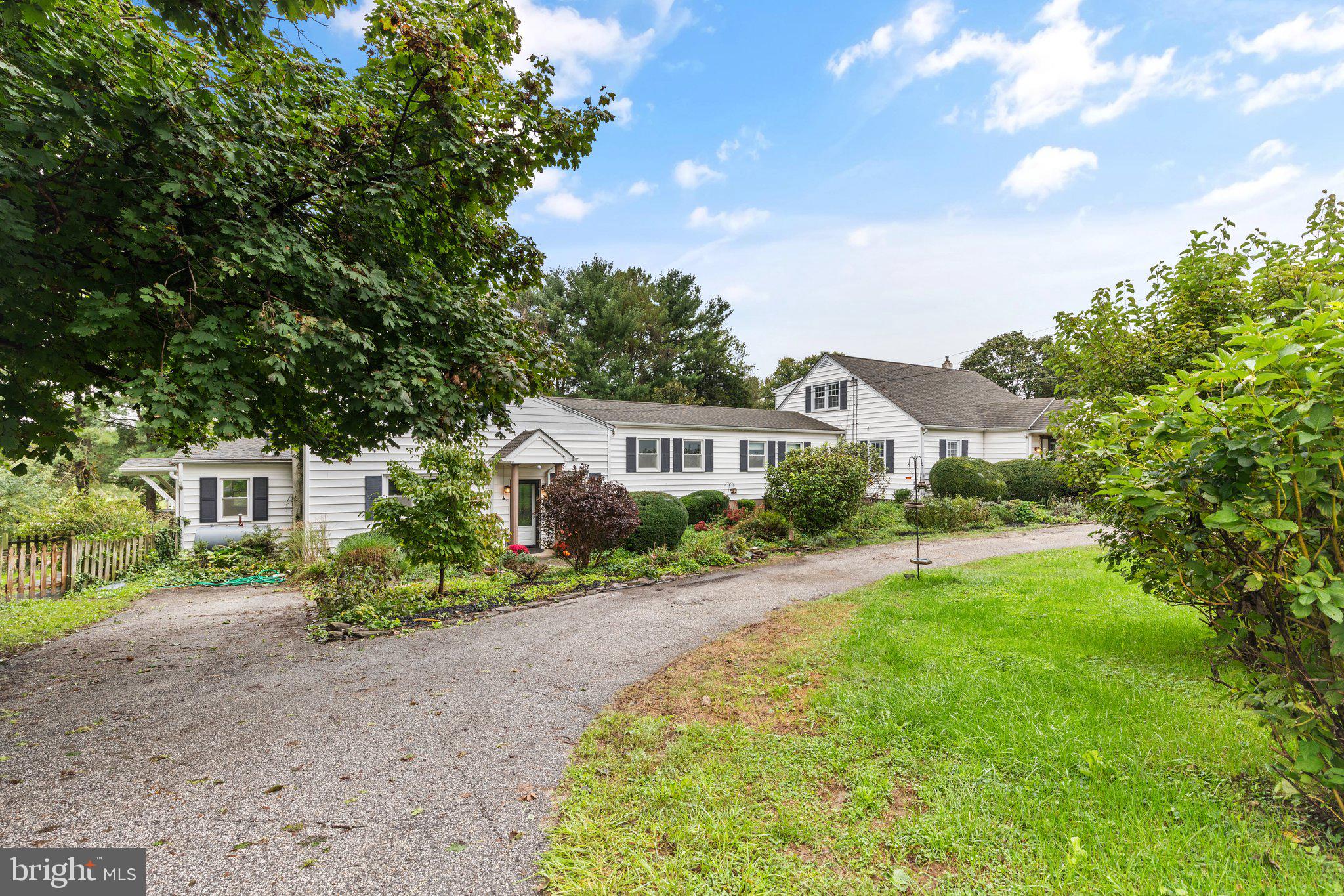 a front view of a house with yard and green space