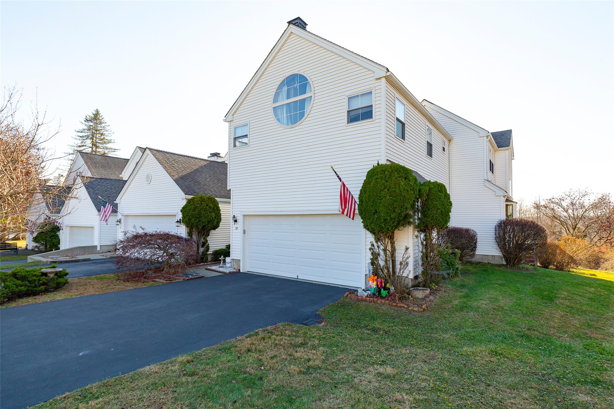 View of home's exterior featuring a garage and a yard