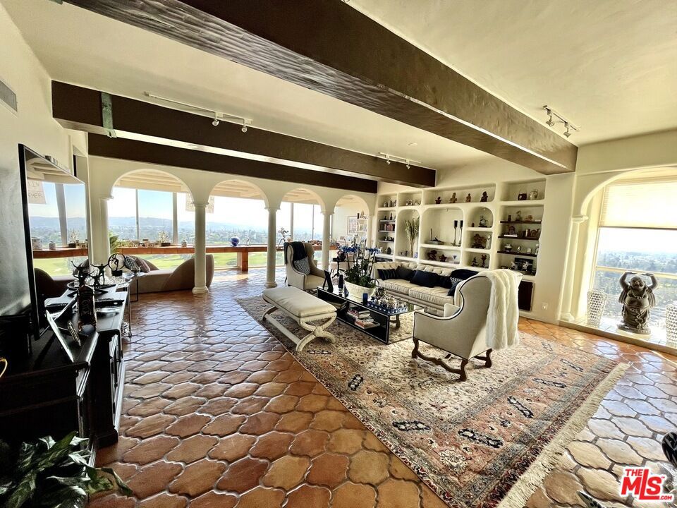 a living room with lots of furniture and a chandelier