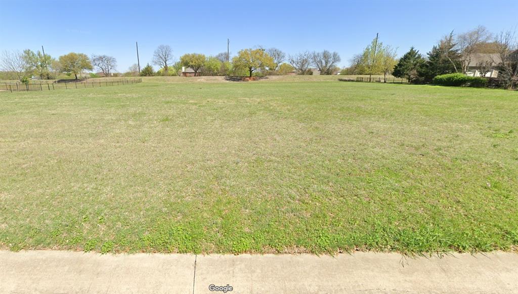 a view of a field with an ocean view