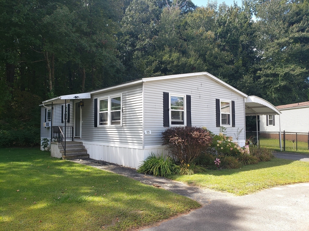 a front view of house with yard and green space