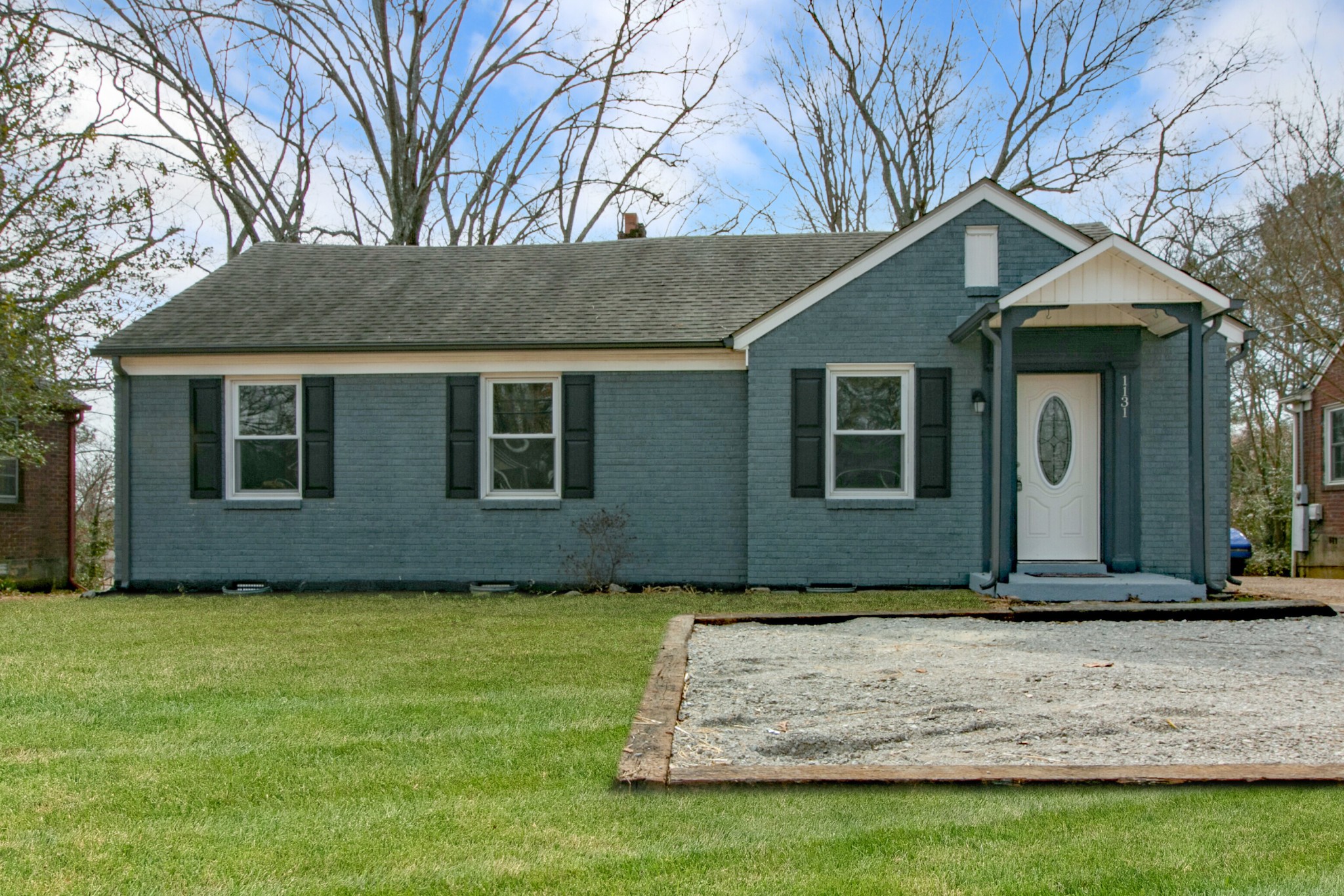 a front view of a house with a garden