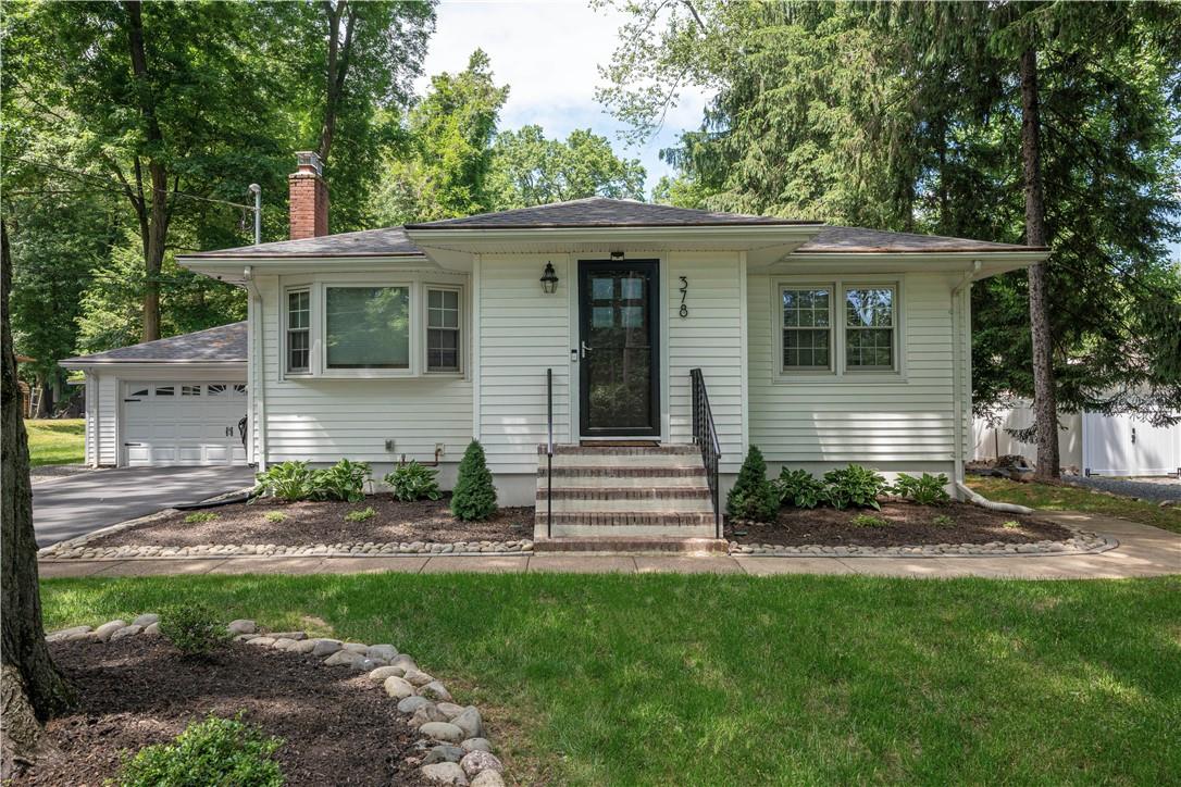 View of front of home with a front lawn and a garage