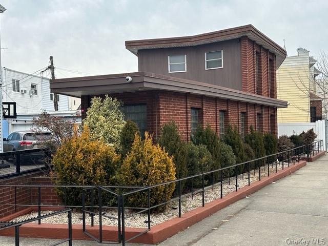 a front view of a house with plants