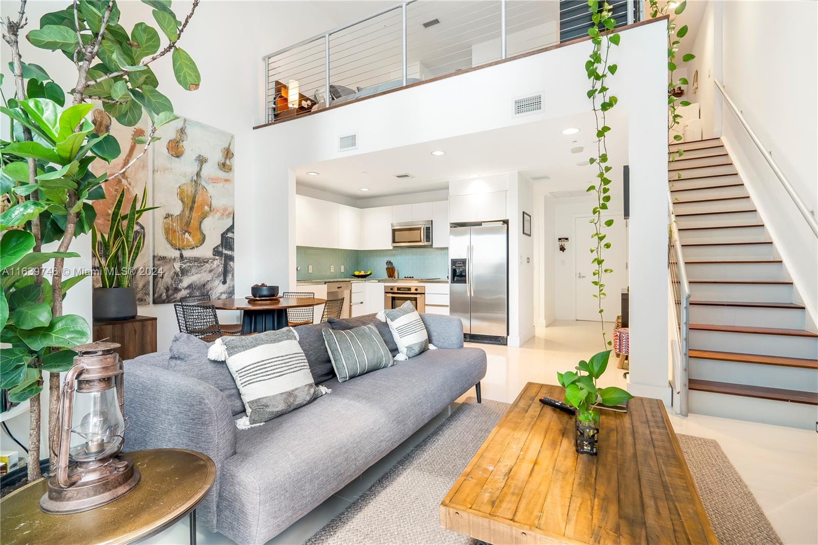 a living room with furniture and a potted plant