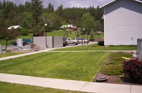 a view of a house with a yard and sitting area