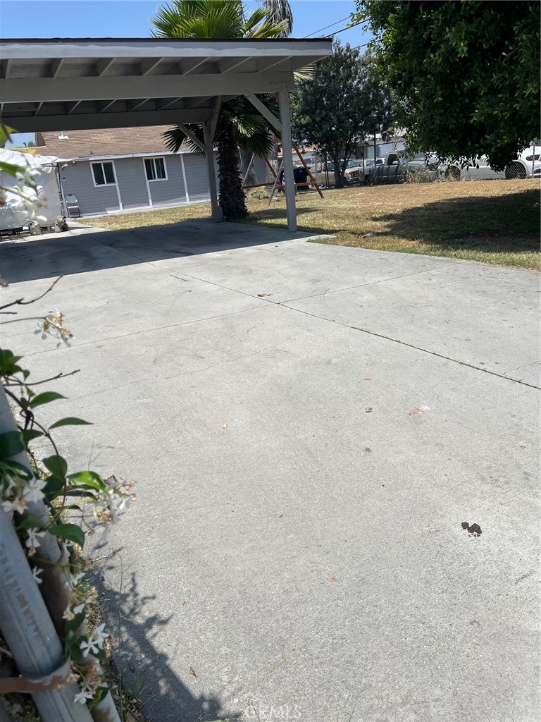 a view of garage with a car parked in it