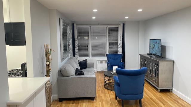 Living room featuring light wood-type flooring and radiator