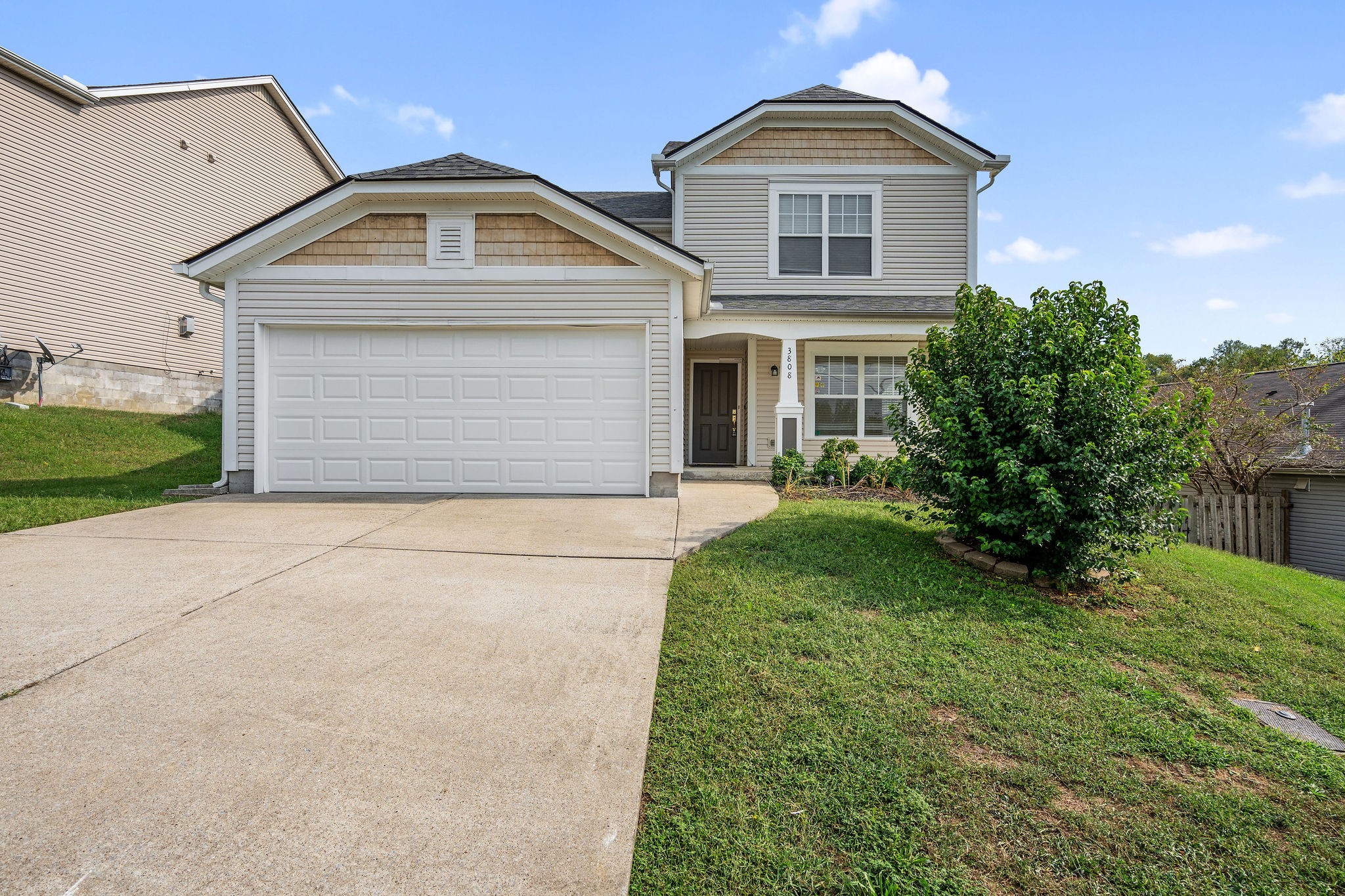 a front view of a house with a yard and garage