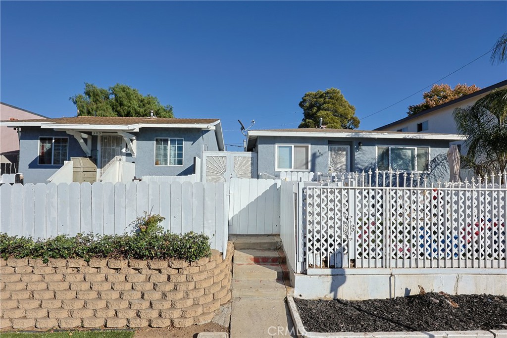 a front view of a house with a fence