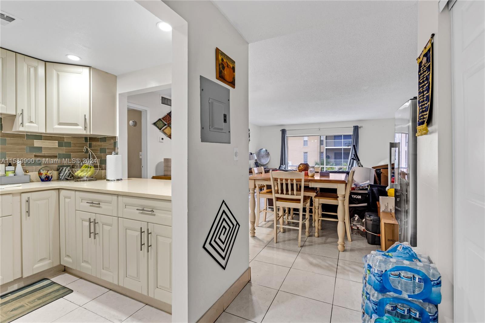 a open kitchen with stainless steel appliances kitchen island granite countertop a table and chairs in it