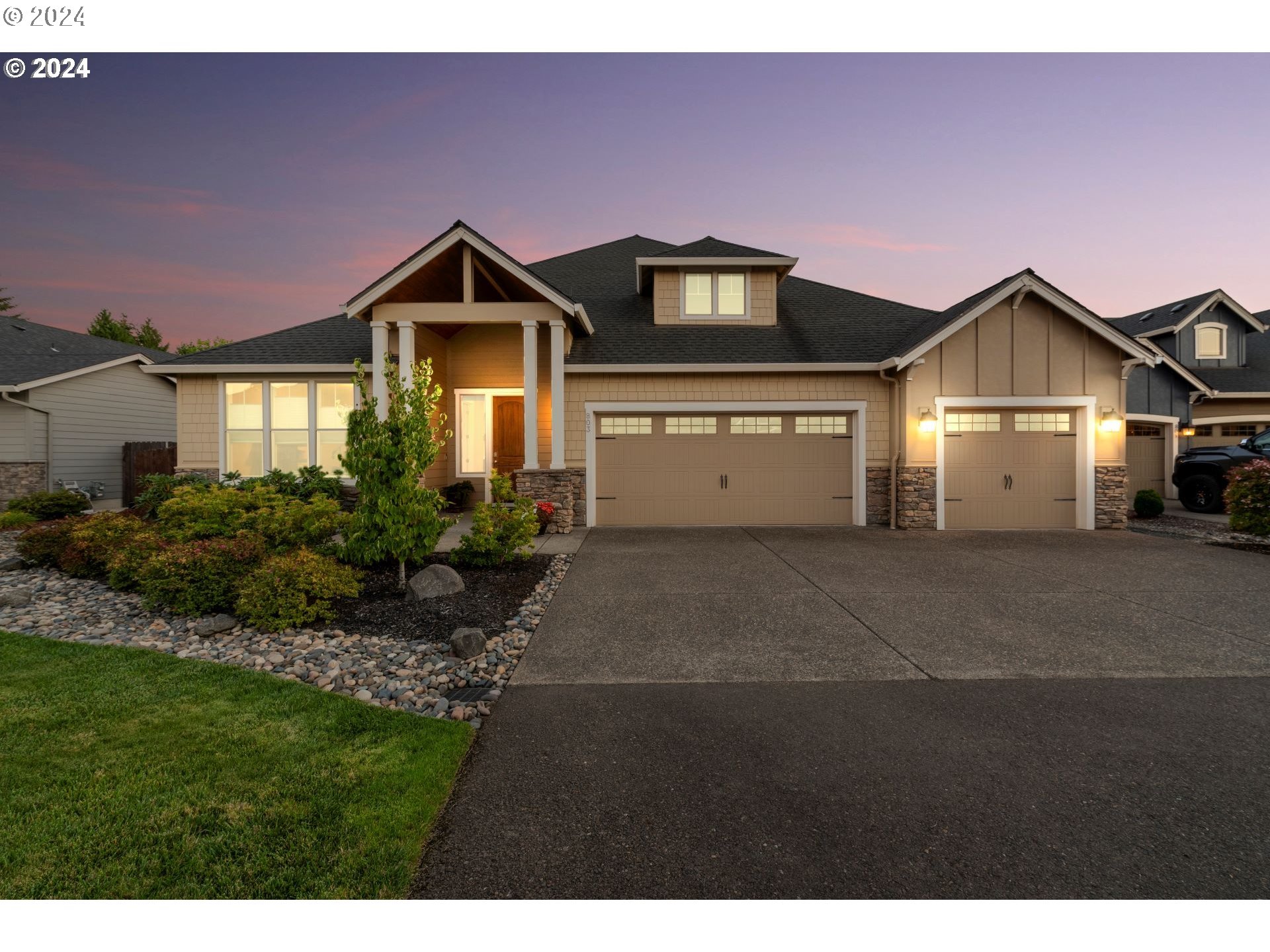 a front view of a house with a yard and garage