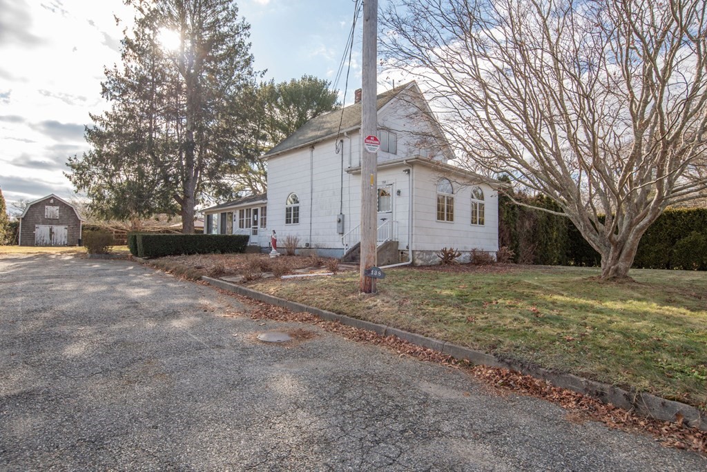 a front view of house with yard and trees