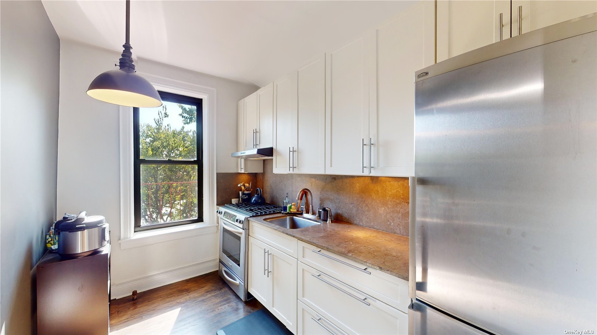 a kitchen with granite countertop cabinets and window