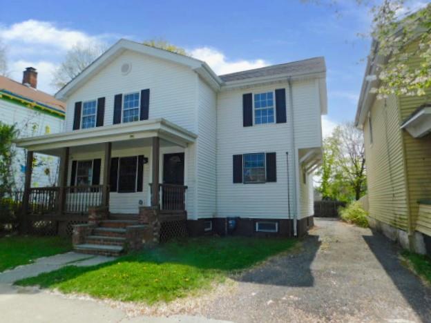 a view of house with yard and green space