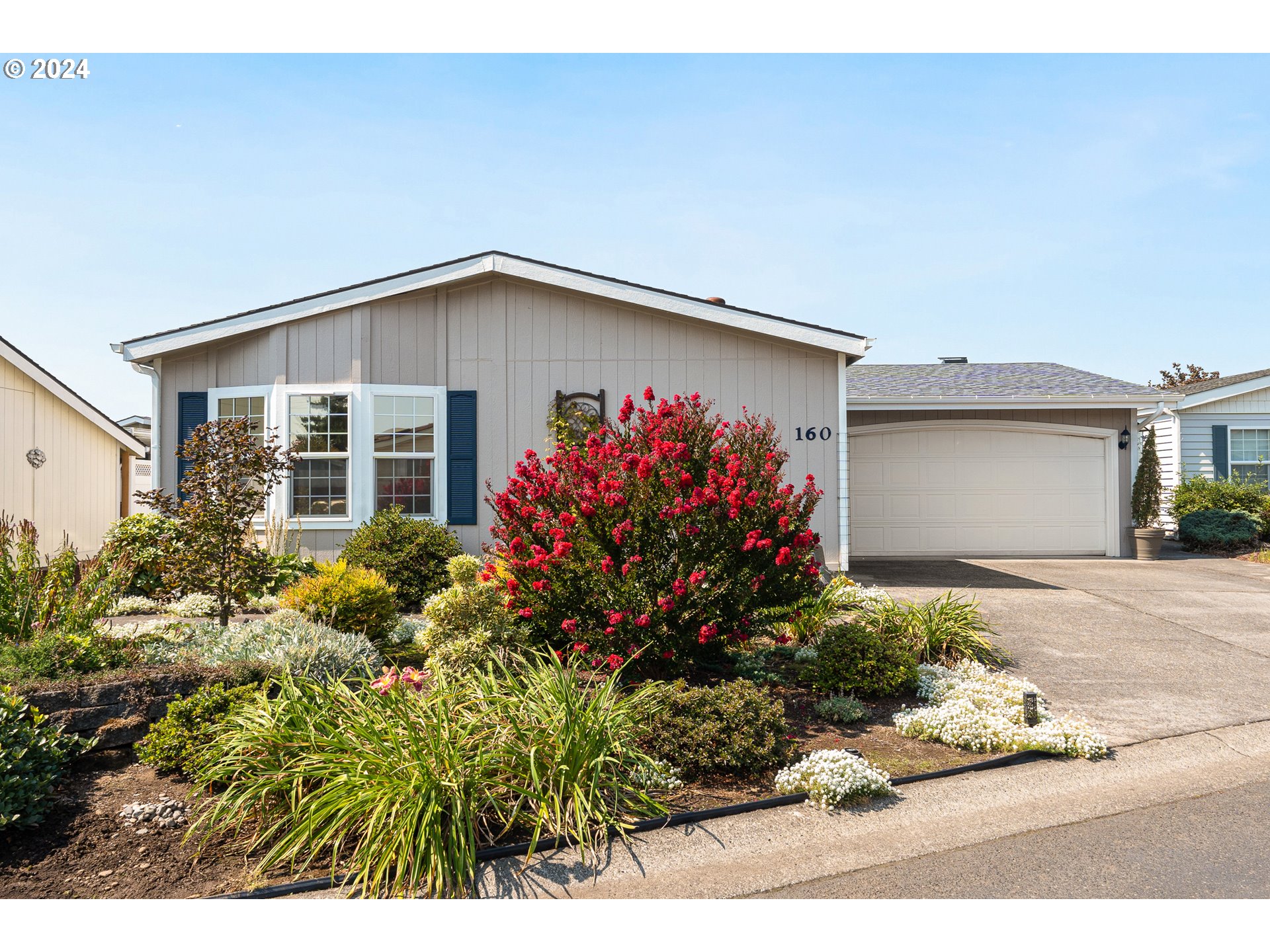 a view of a house with a flower garden